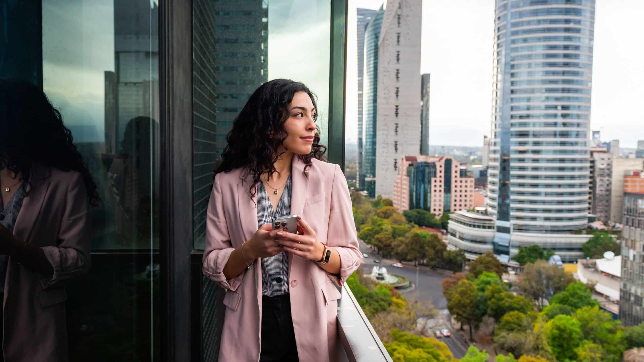 Confident professional overlooking city skyline - the authority lifestyle you deserve